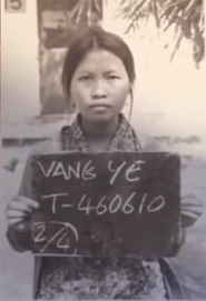 Young immigrant woman holding a sign.