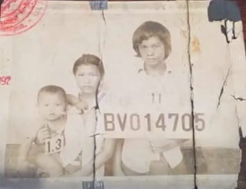 Young immigrant mother, father and child with number sign.