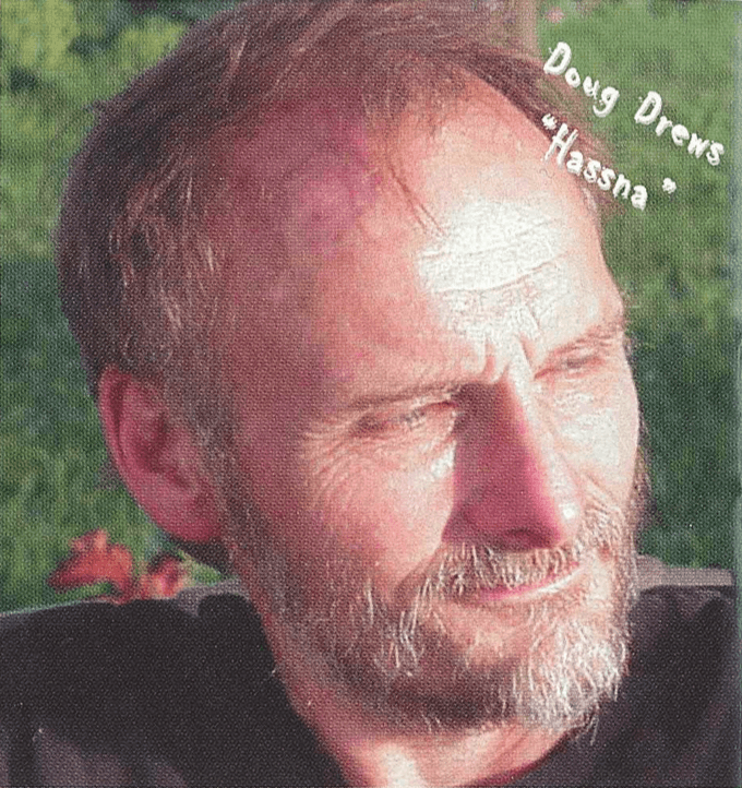 Contemporary image of an older gentleman looking off camera, sitting outside in the sun. Text on photo says "Doug Drews "Hassna"."