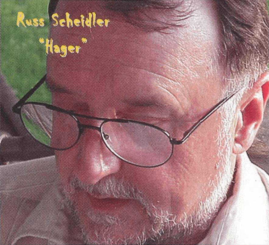 Contemporary photo of an older gentleman, eyes turned away from the camera. Text on photo says "Russ Scheidler "Hager"."