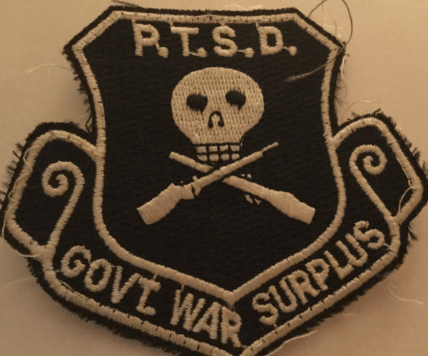 Black and tan patch that says P.T.S.D. Govt. War Surplus.