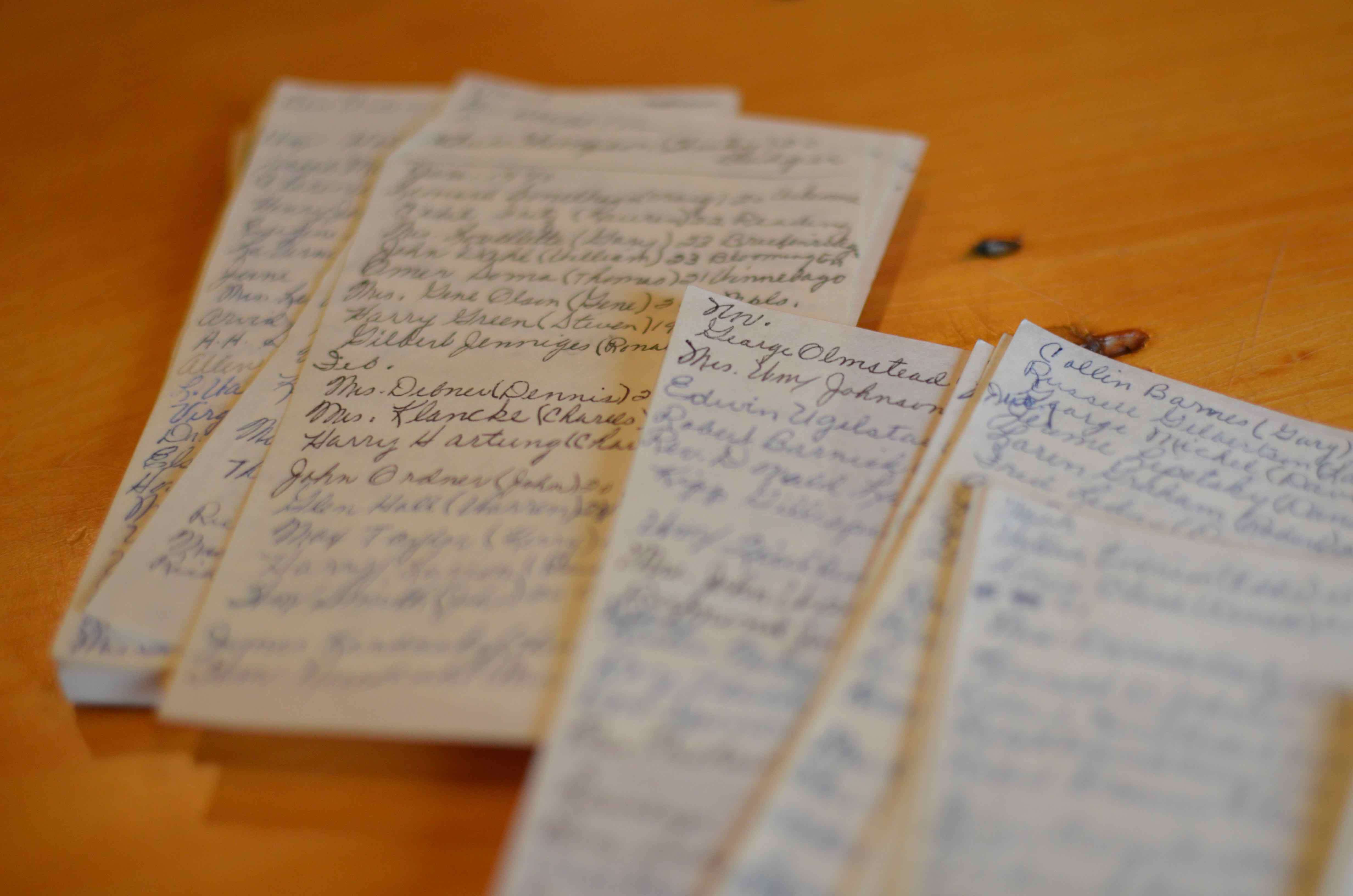 Stack of hand-written letters on a table.