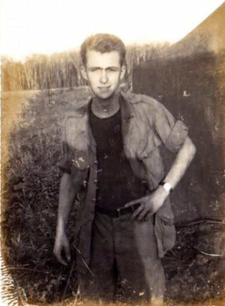 A worn photo of a young soldier in a clearing during some downtime.