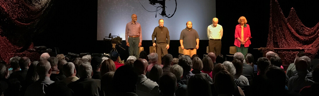 Cast performing a play on stage