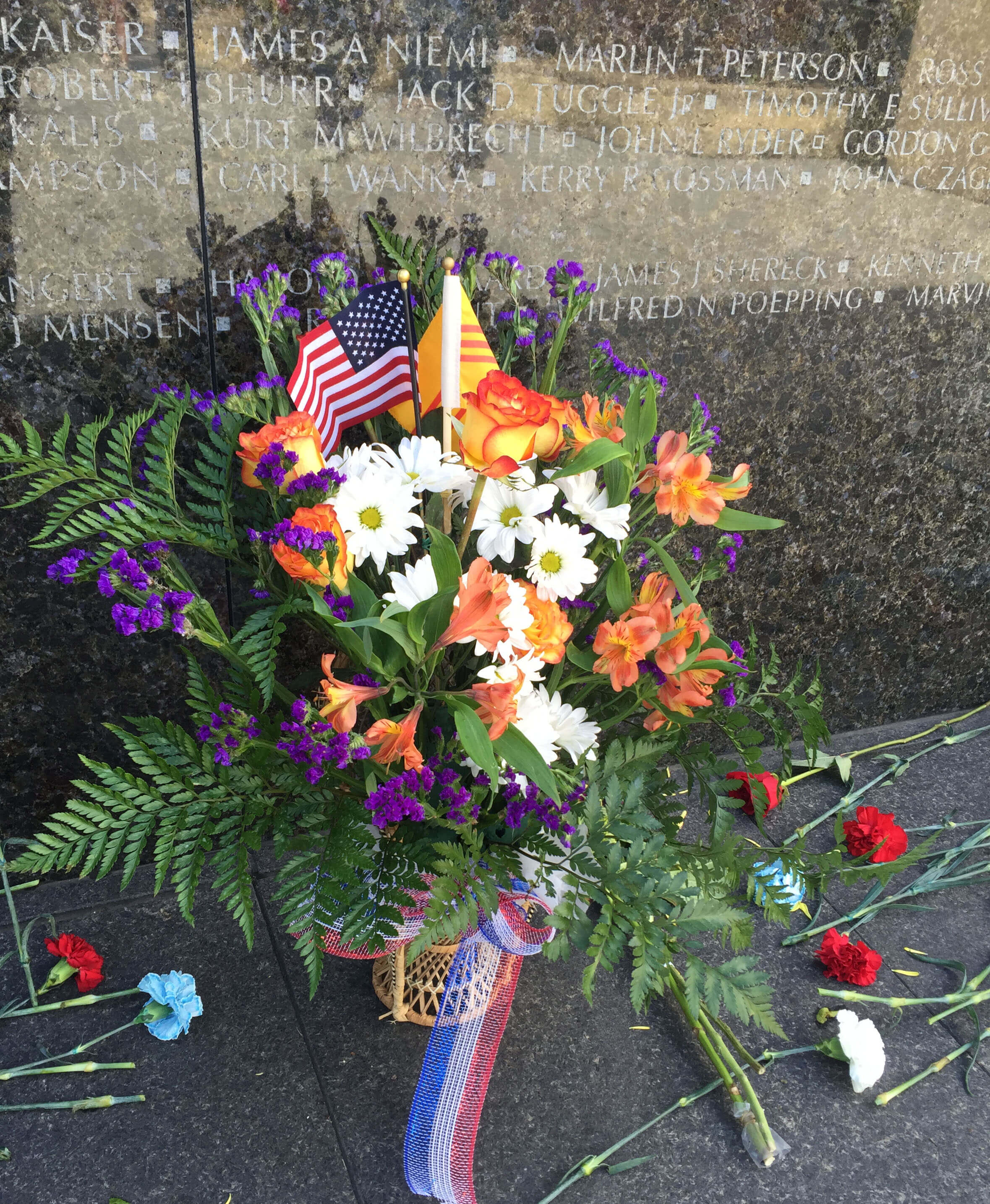 Colorful flowers and American flag at the Minnesota Vietnam Veterans Memorial,
