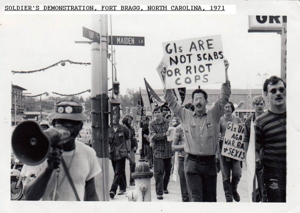 Group of young people protesting the Vietnam War with signs.