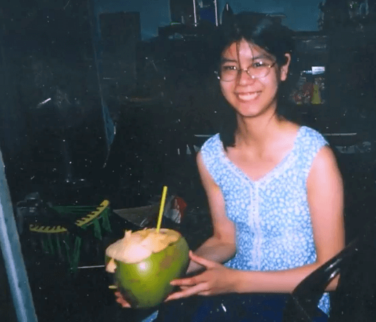 Young Vietnamese woman holding a coconut.