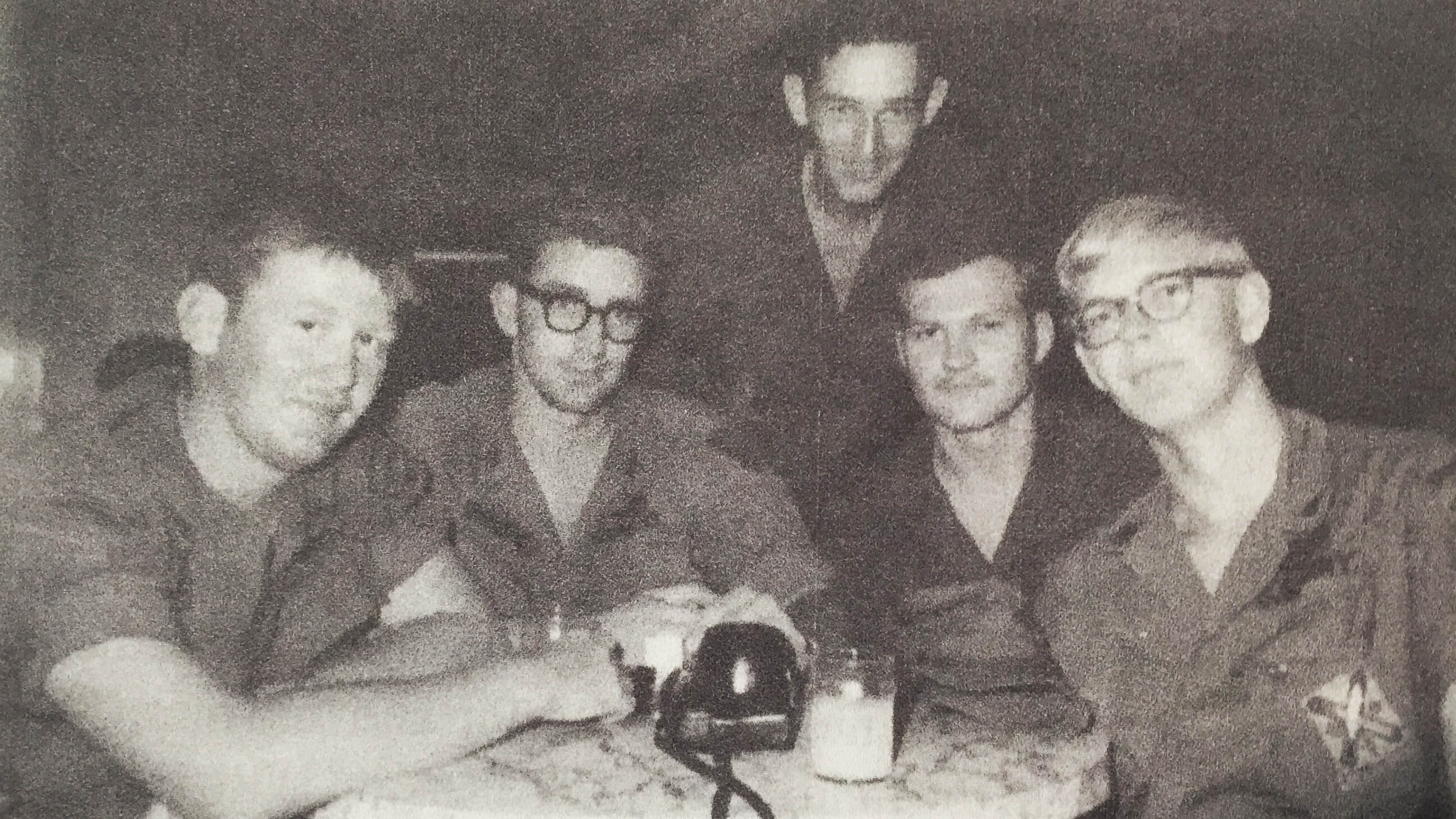 Group of young Vietnam War soldiers at a table.