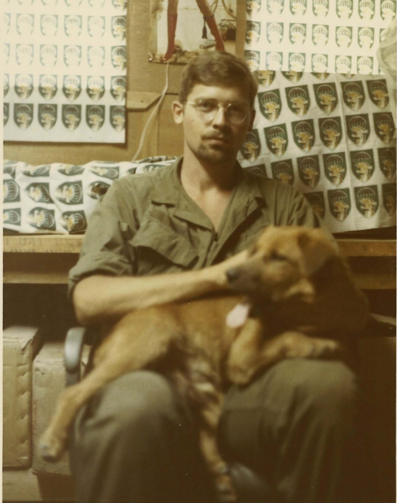 American soldier with a brown dog.