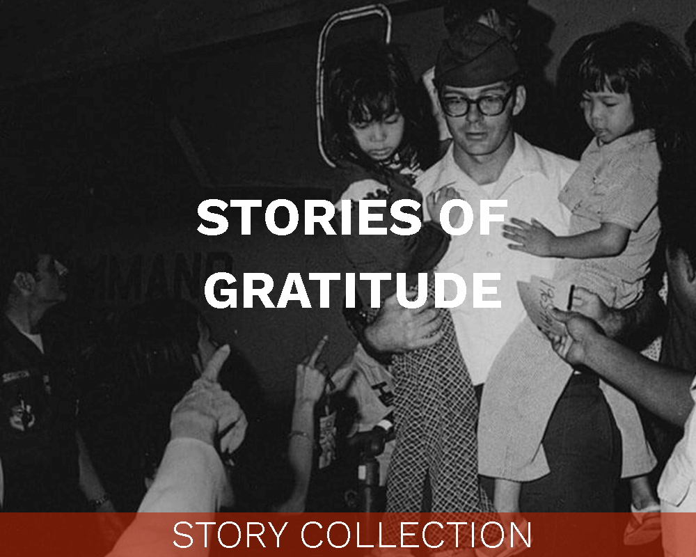 A US pilot carrying two Asian children down plane steps. Text on image says "Stories of Gratitude: Story Collection".