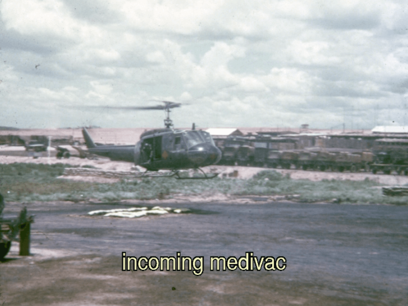 A helicopter outside an encampment. Text on photo says "incoming medivac."