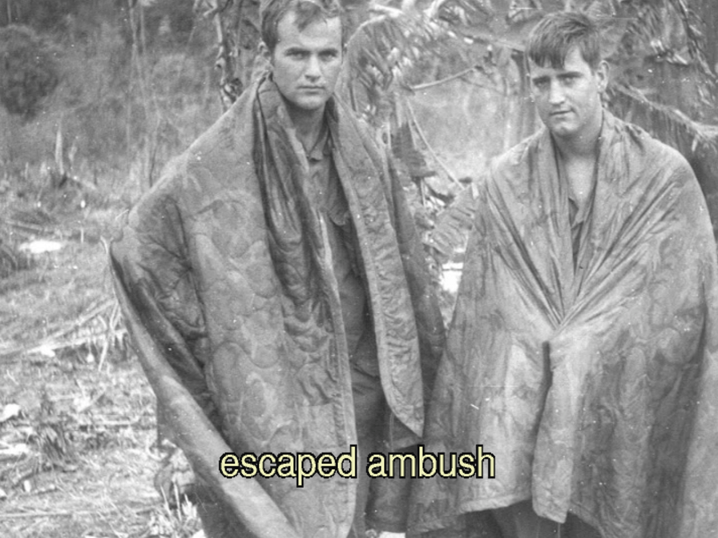 Two stern-looking soldiers wrapped in blankets. Text on photo says "escaped ambush."