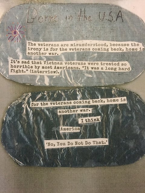 Close up of two "dog tag" middle school projects. "Borne in the USA. The veterans are misunderstood, because the irony is for the veterans coming back, home is another war..." And "For the veterans coming back, home is another war. I think America 'No, You Do Not Do That.'"