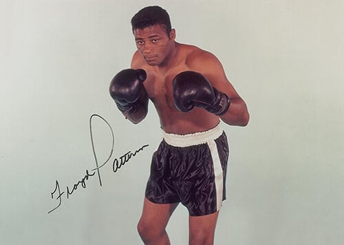 A signed photograph of Floyd Patterson, shirtless with his boxing gloves on.