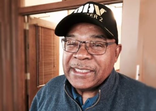 Contemporary photo of an older black man, wearing a Disabled American Veterans DAV ball cap.