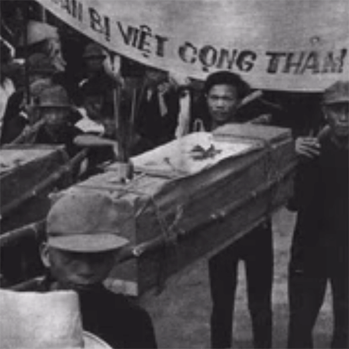 Vietnamese men carrying a casket.