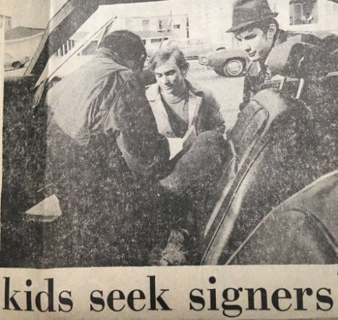 Newspaper clipping, an image of students petitioning. Headline says "kids seek signers"
