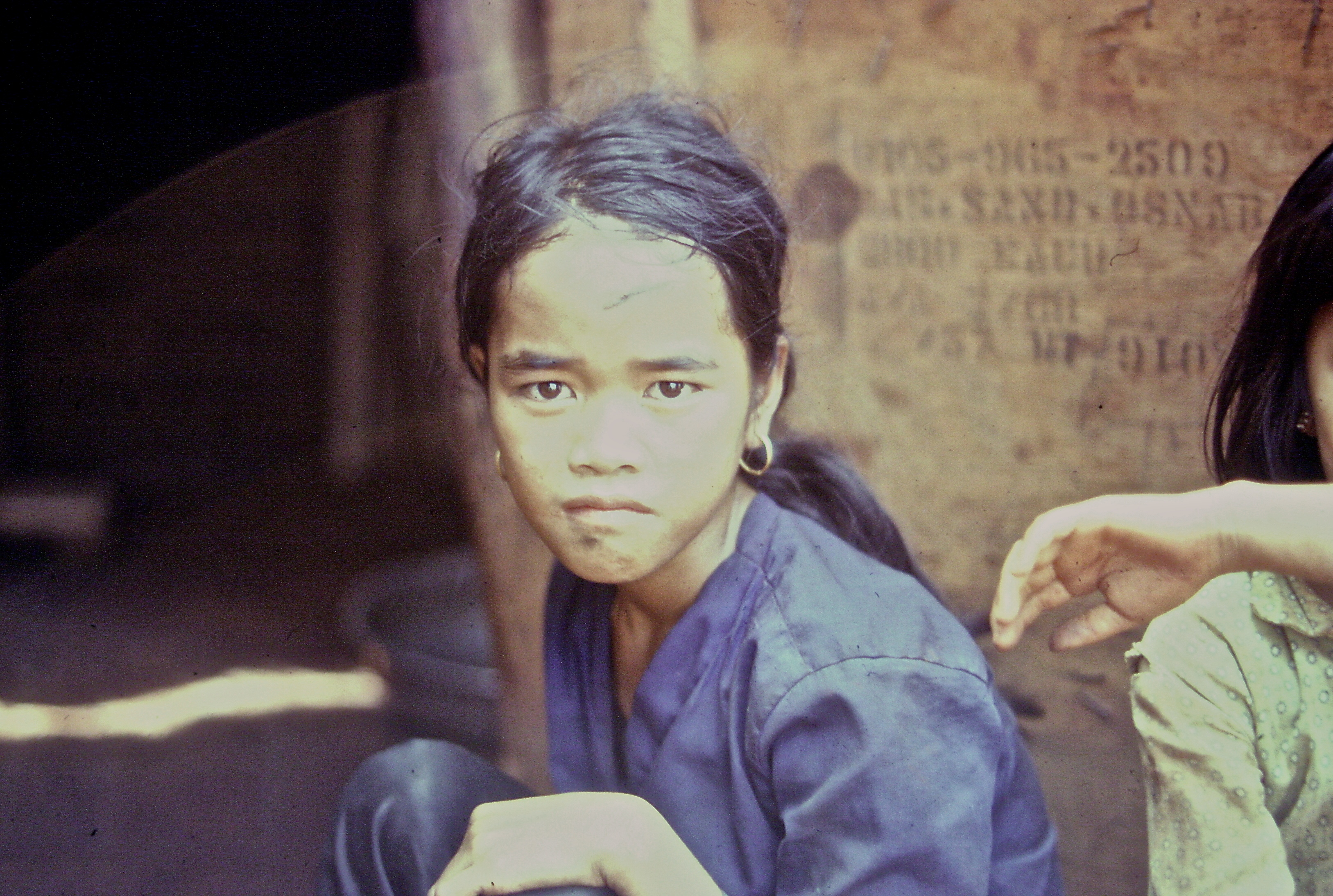 A young Asian woman looking sternly into the camera.