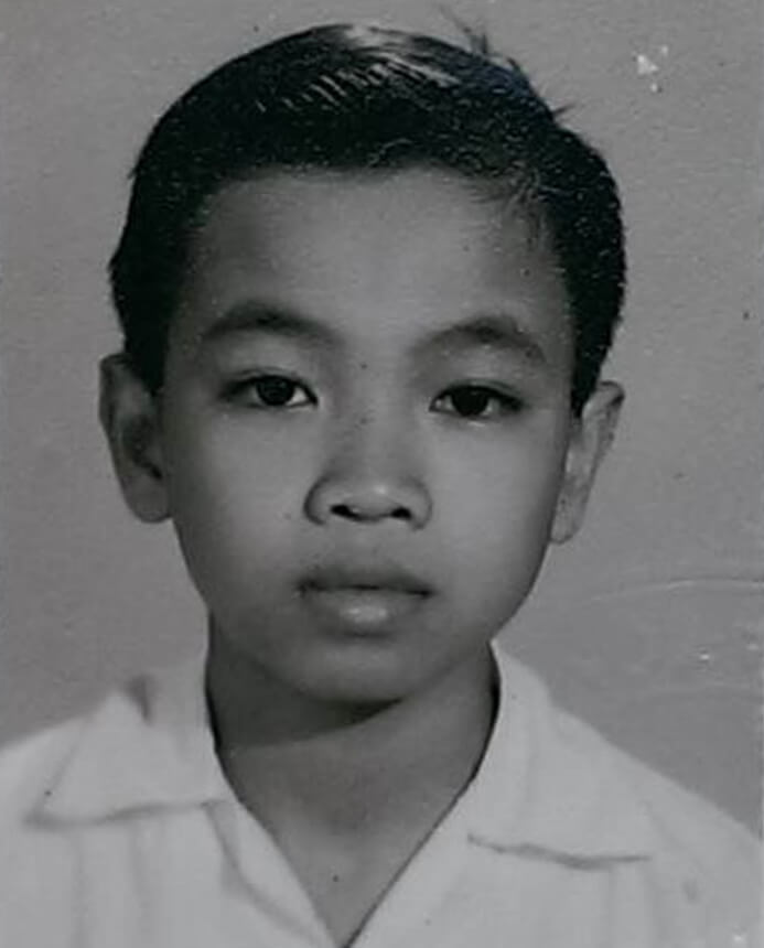 Black and white portrait of a young Vietnamese boy.