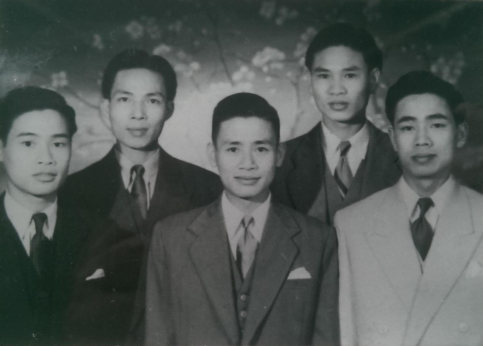 Black and white photo pf five young Vietnamese men in suits.