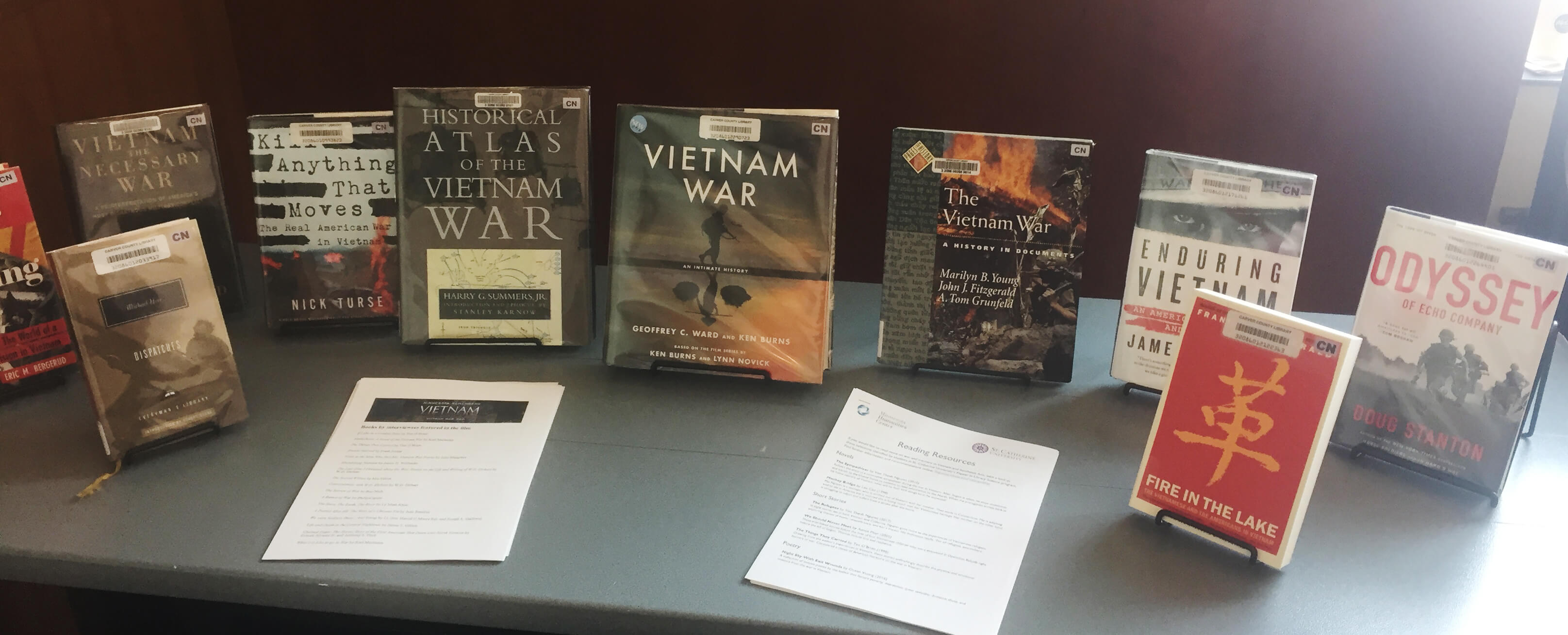 Vietnam War-related books on a table at a library.