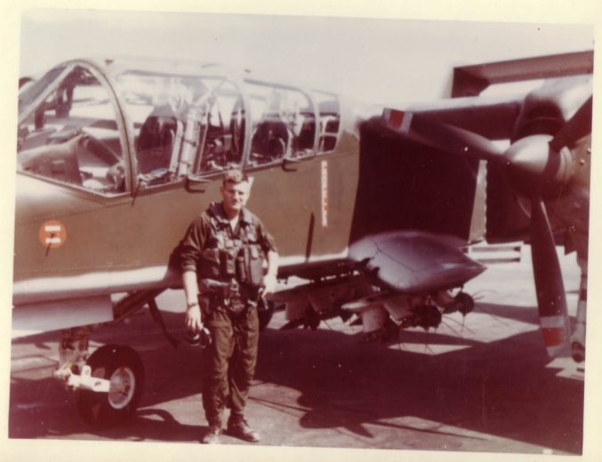 A pilot standing in front of his aircraft.