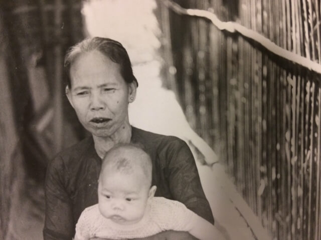 Black and white photo of a Vietnamese mother and infant.