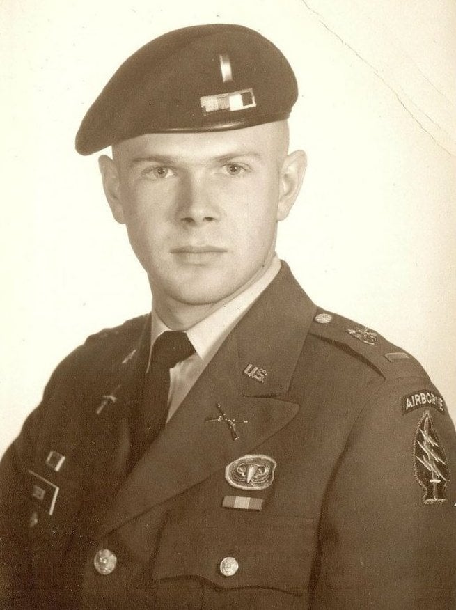 Official military portrait of a young man wearing a beret, with the Special Forces Airborne insignia on his upper left arm.