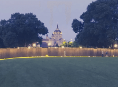 A replica of the Vietnam Veterans Memorial Wall lit up at night.
