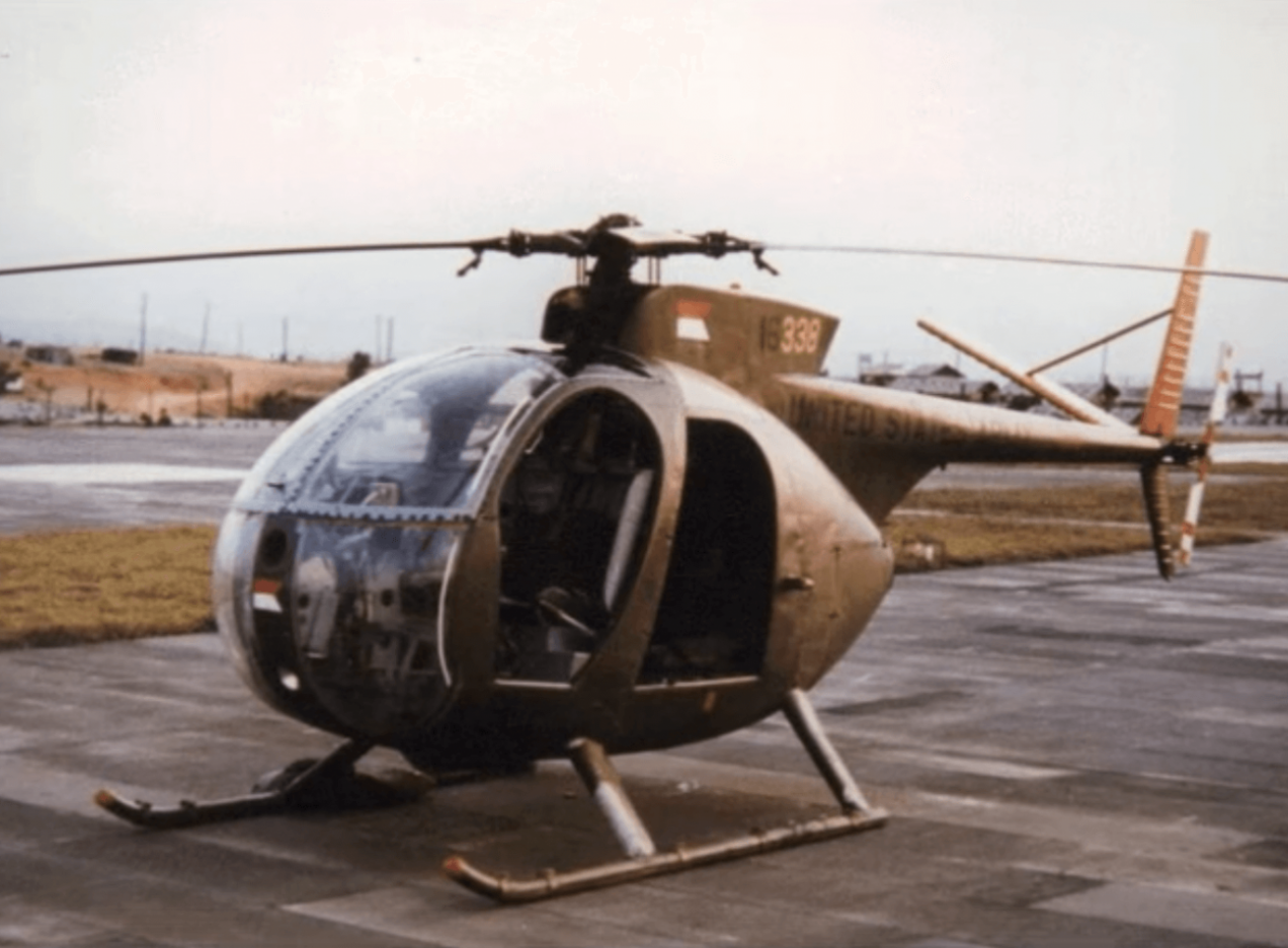 A very small helicopter on a tarmac.