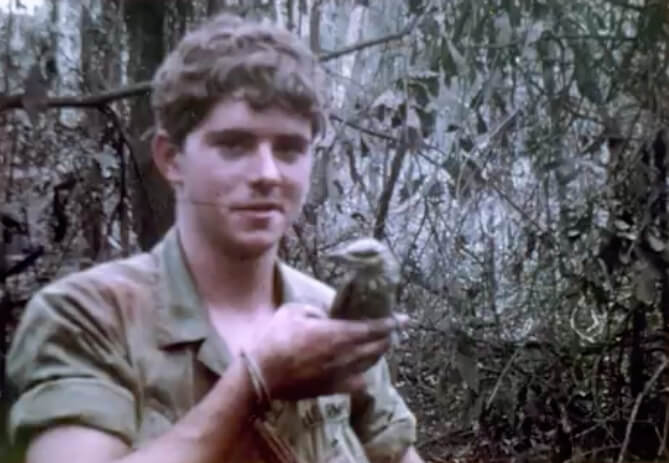 Photo of a young soldier holding a bird.