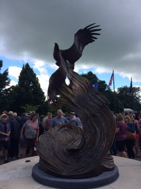 Bronze sculpture of an eagle and waves.