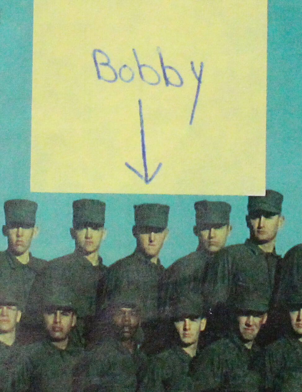 Portrait of a group of young soldiers with a note and arrow pointing to a soldier named Bobby.