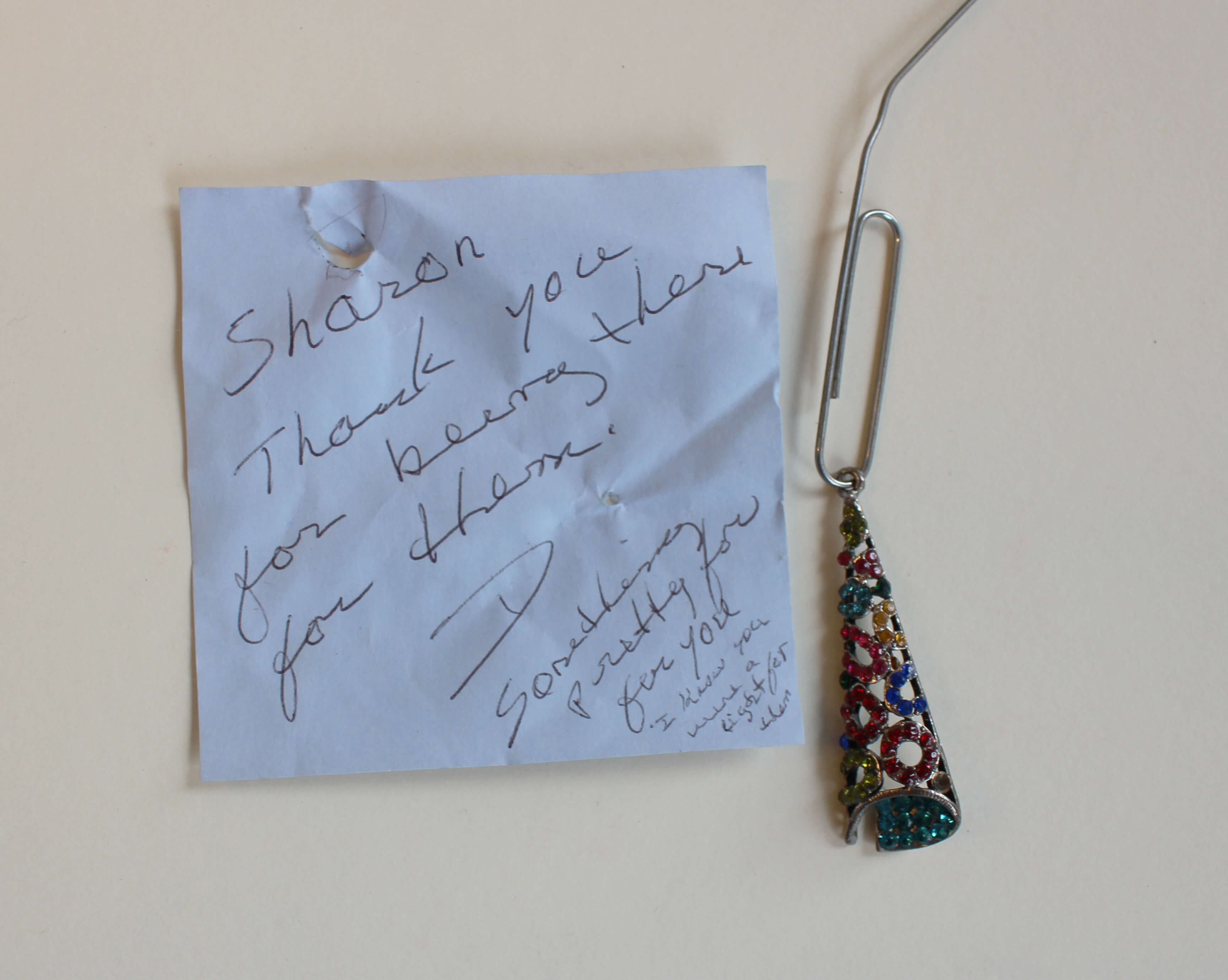 Jeweled charm and handwritten note.