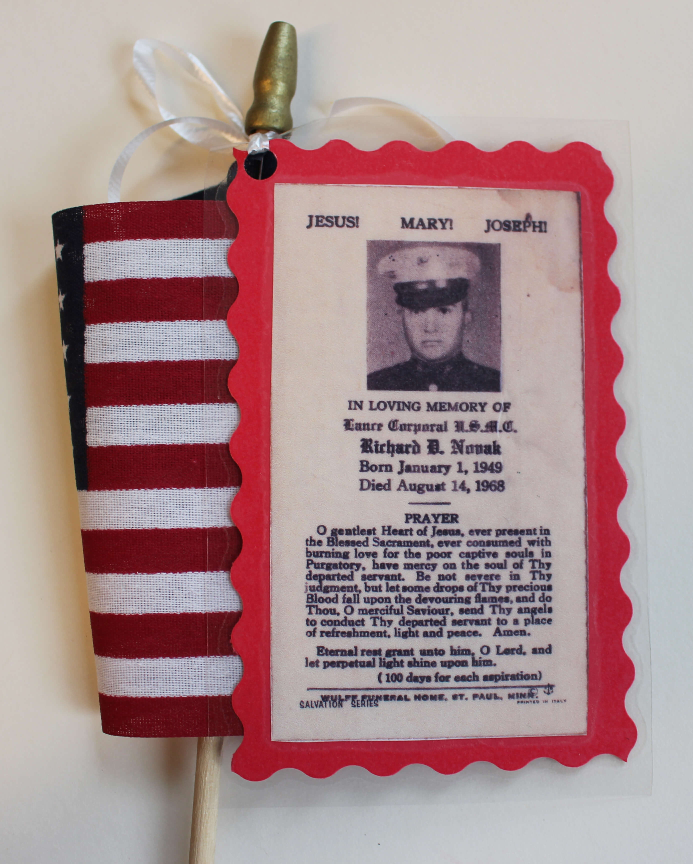 American flag with memorial tribute to Lance Corporal U.S.M.C. Richard D. Novak