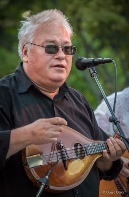 Man playing mandolin outside
