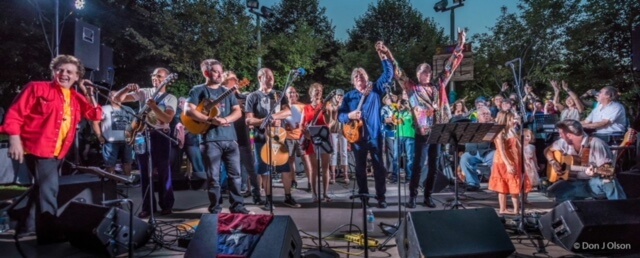 Large band on stage in a park