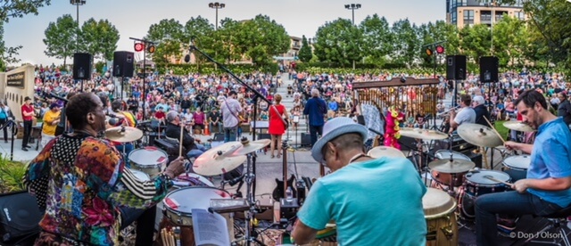 Large band performing in a park.