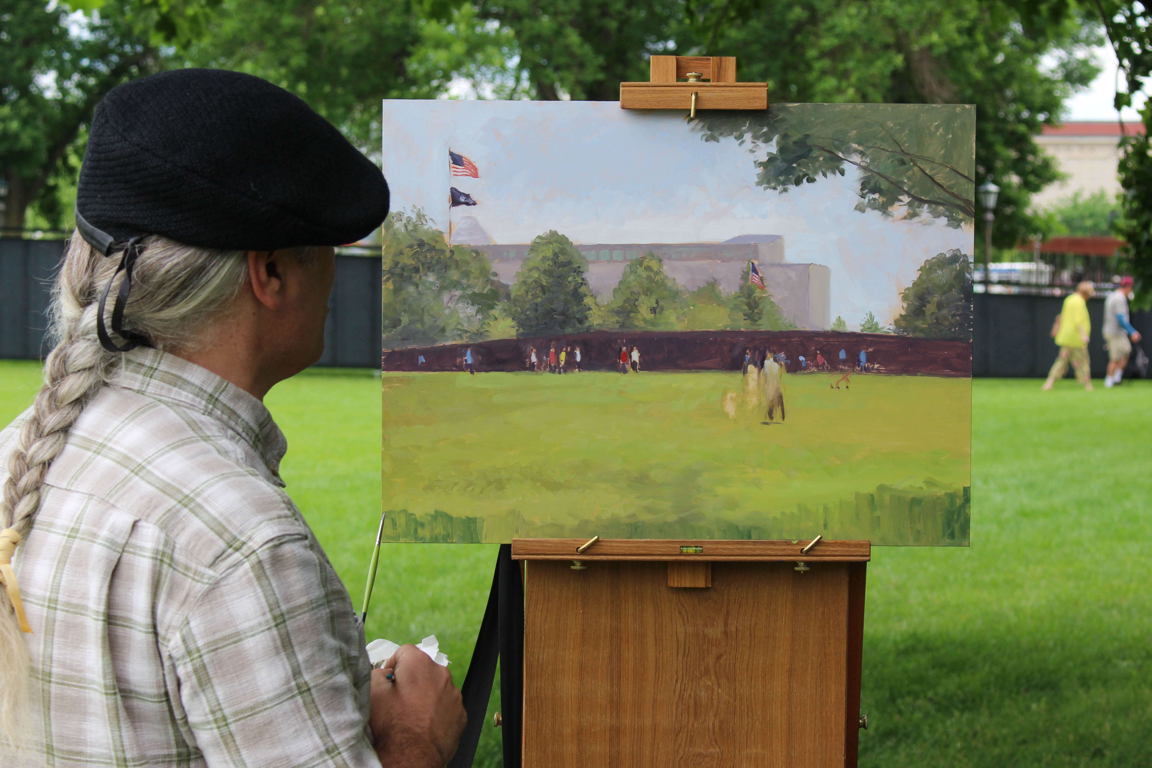 Man with painting outside.