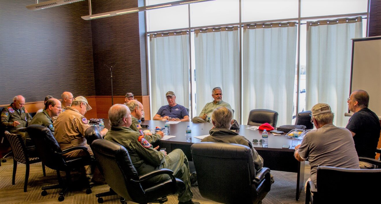 Group of pilots meeting at a table