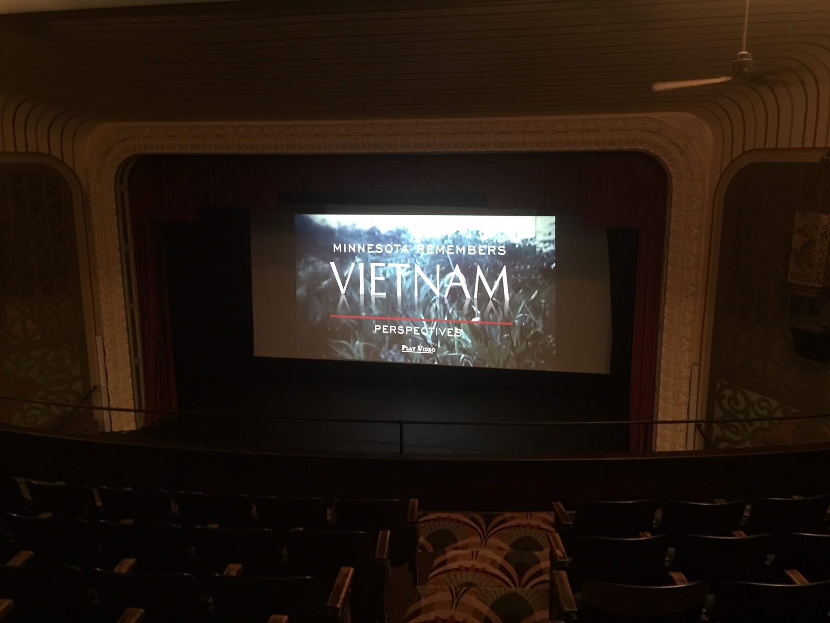 Vietnam War film playing on a screen in a dark theater