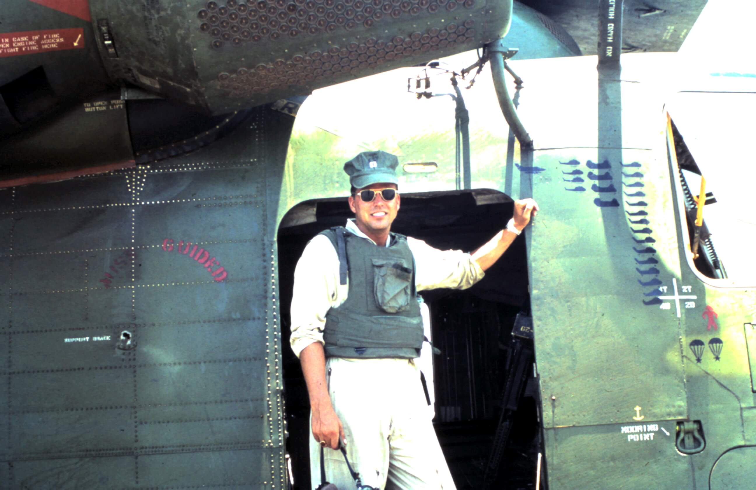 Pilot in front of a helicopter.