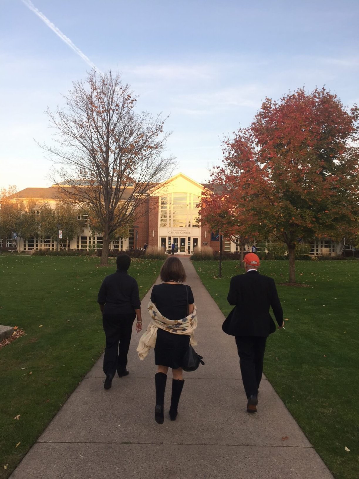Three people walking on a college campus