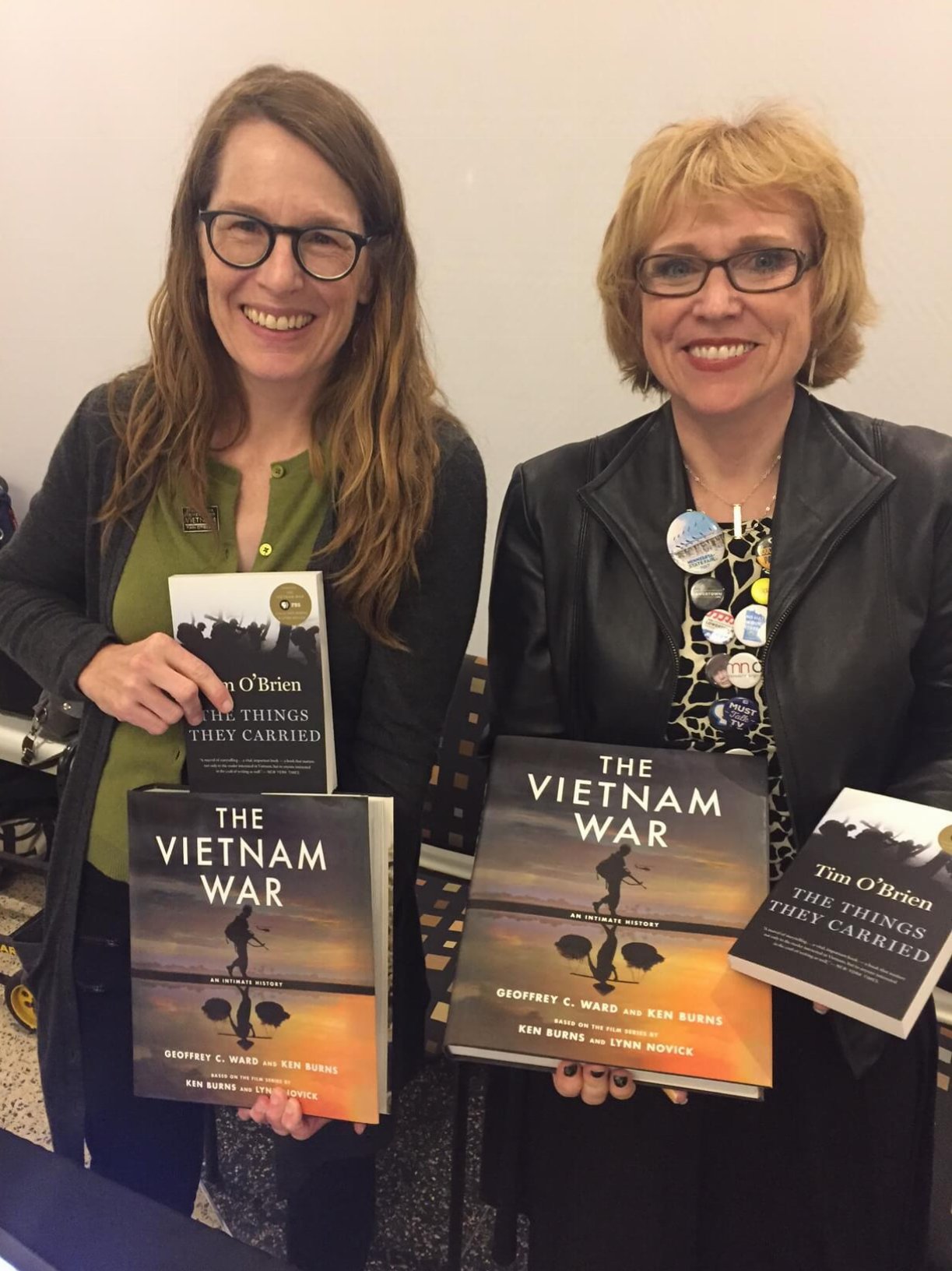 Two women holding copies of Vietnam War books
