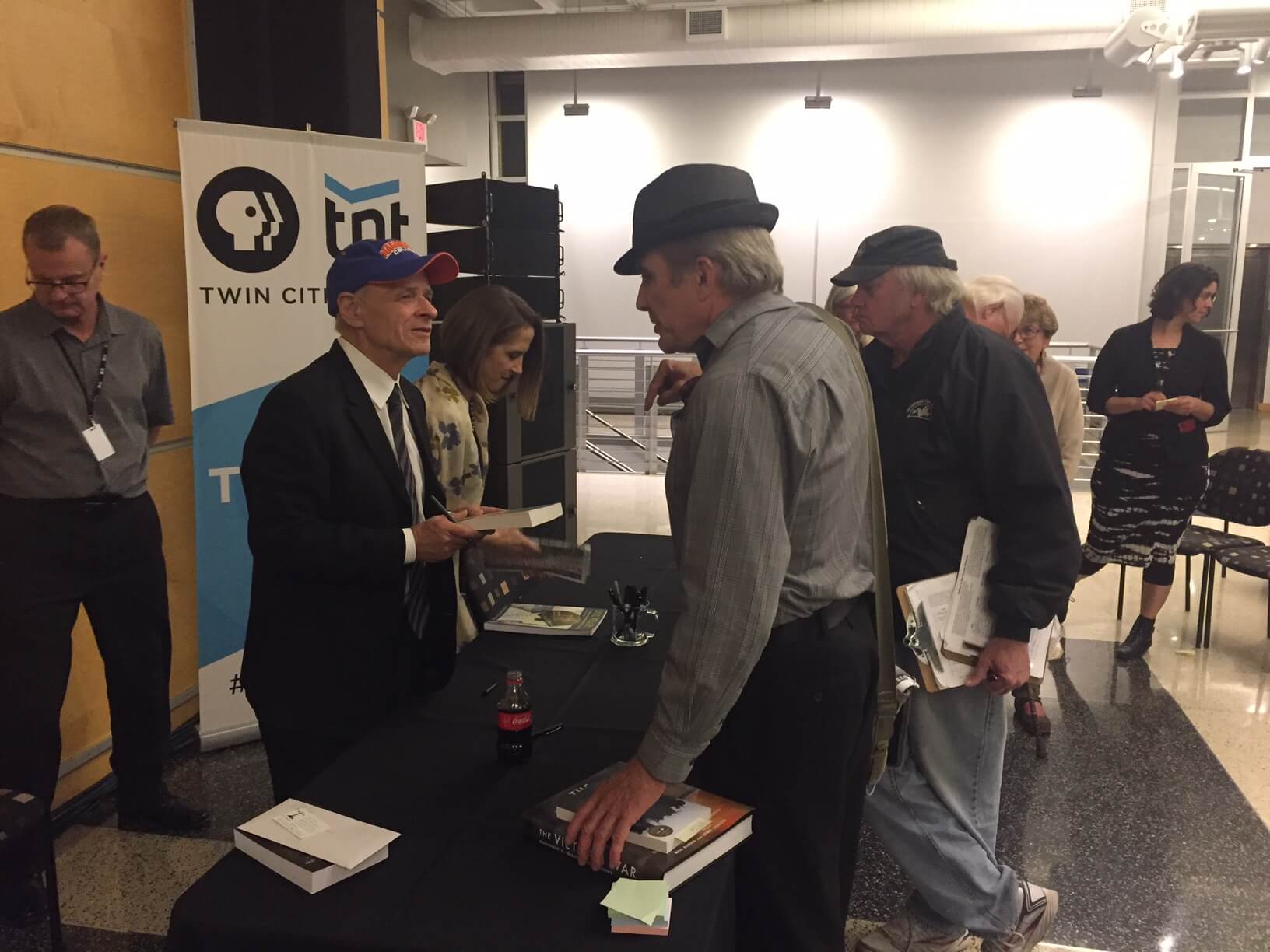Minnesota author and Vietnam veteran Michael Maurer gives his book to Tim O'Brien after the event.