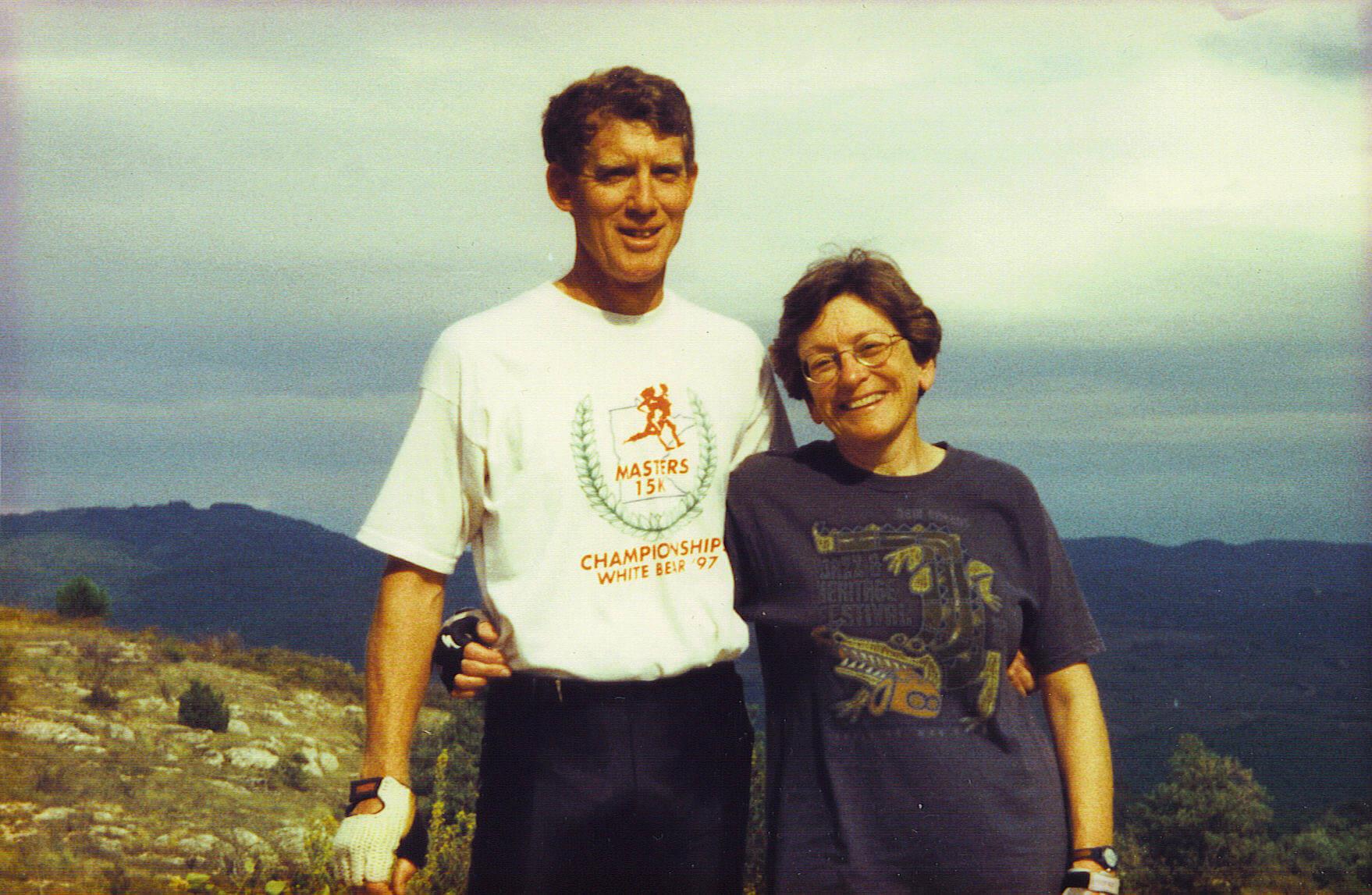 Couple on top of a mountain smiling