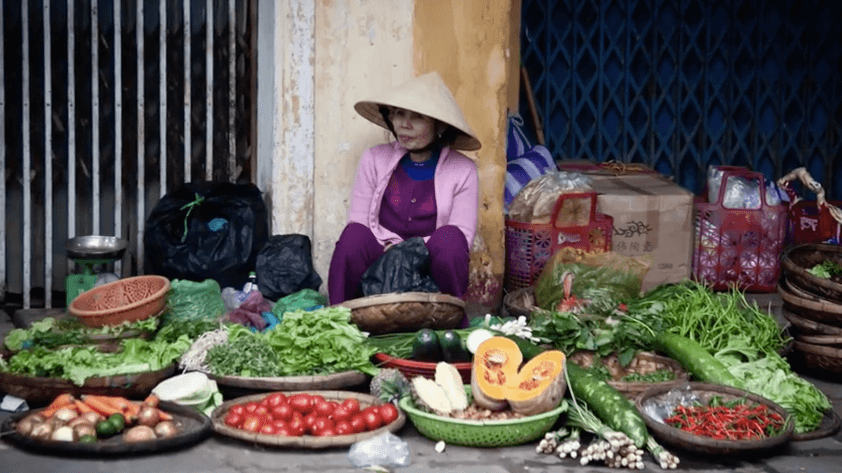 Vietnamese woman selling vegetables at a market