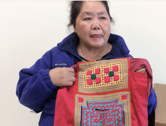 Hmong woman with embroidered baby carrier
